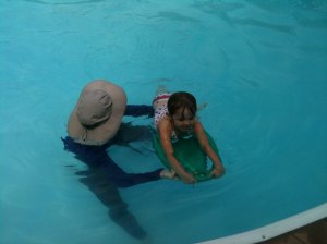 My daughter learning to swim...No helmet or shoulder pads required.
